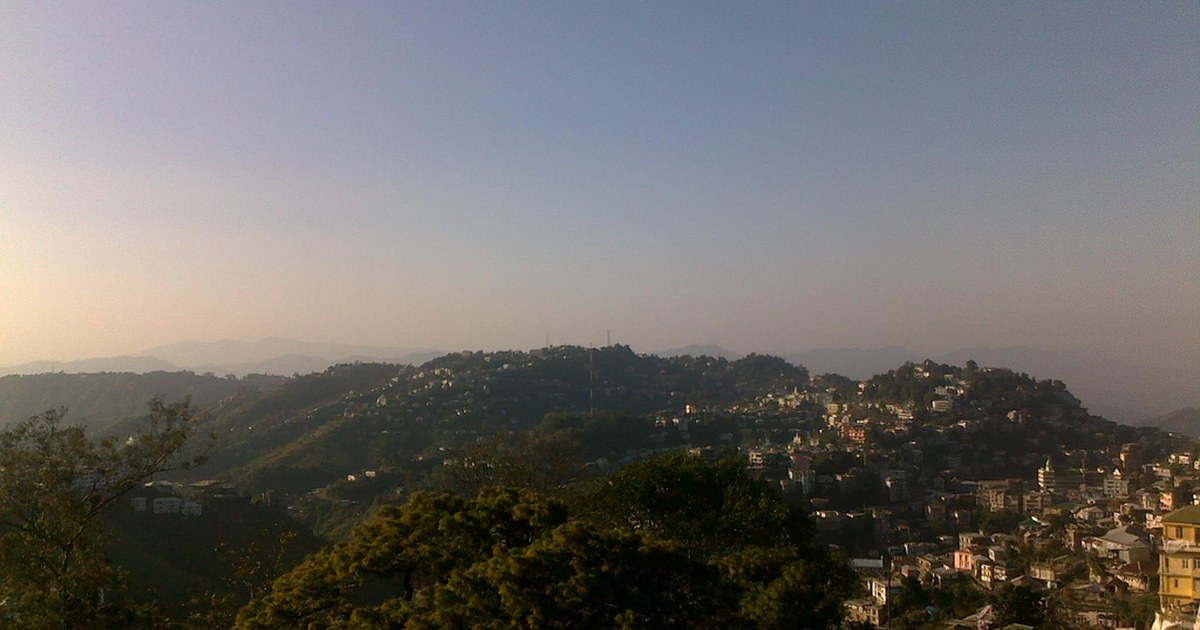 Aizawl city spread across forested hills in daylight