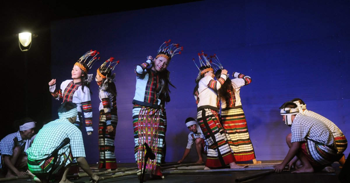 Mizo dancers stepping between bamboo poles at IFFI 2013 in Goa