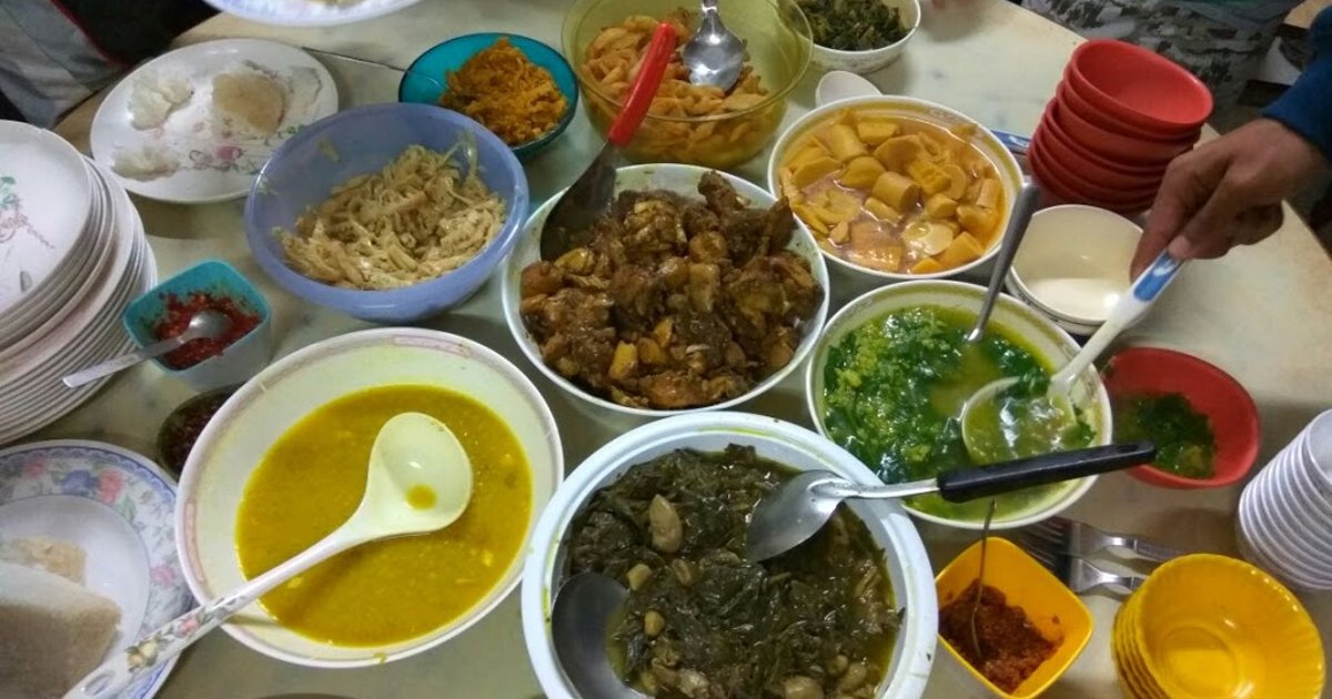A table set with shared Mizo dishes, rice, vegetables and tea