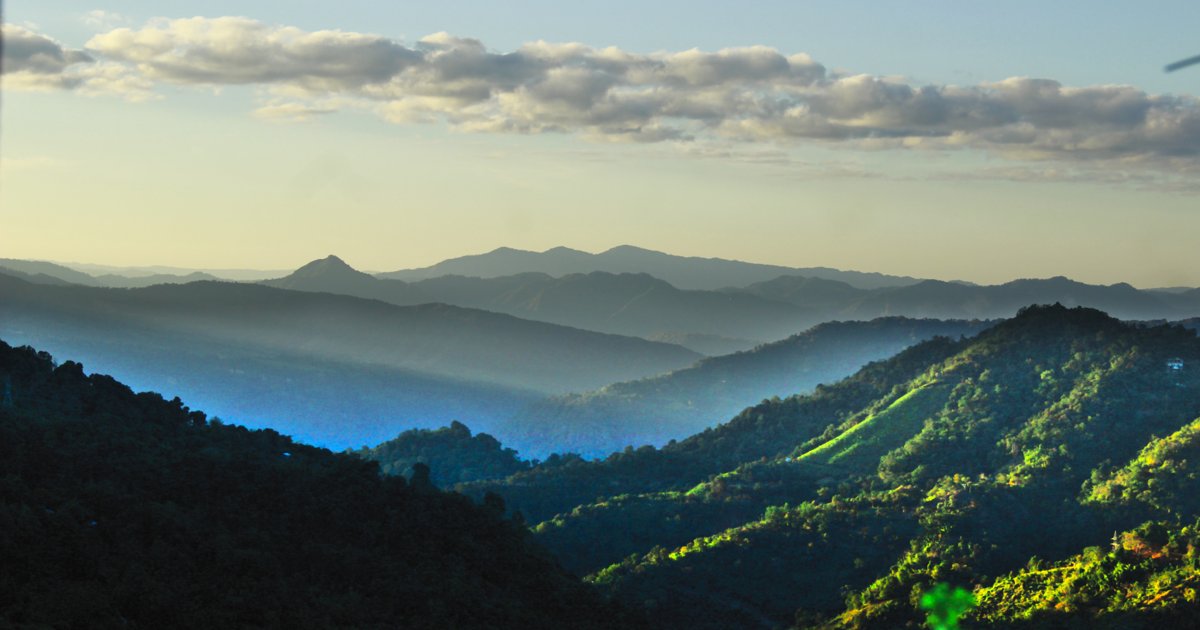 Green hills and a mist-filled valley seen from Hlimen Damveng, Mizoram