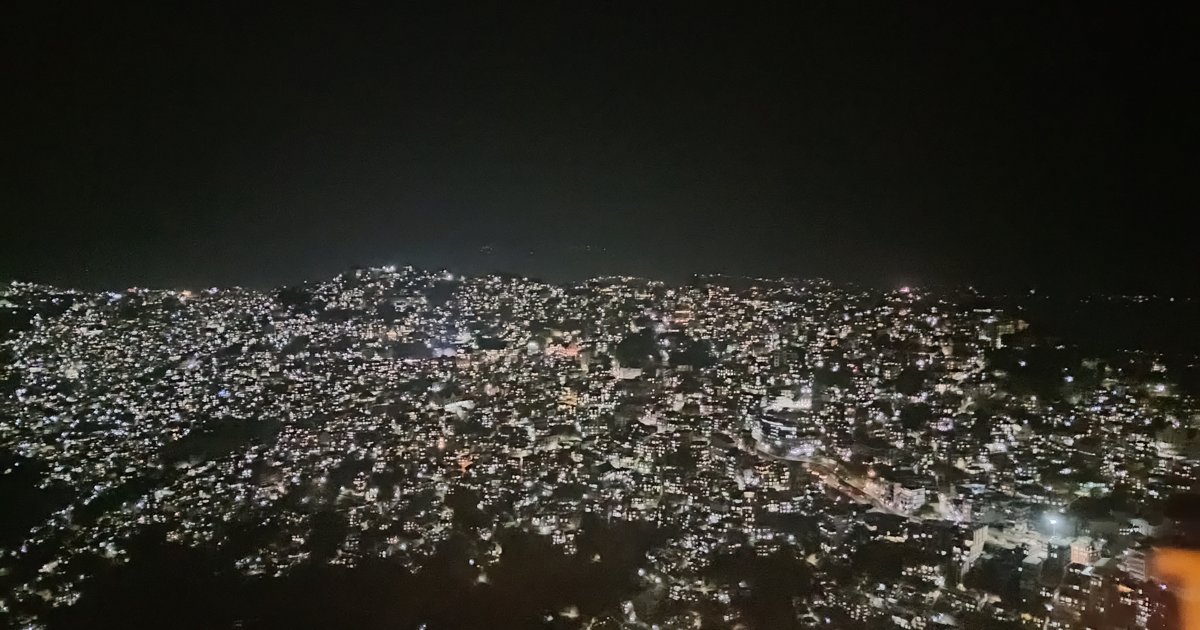 Aizawl illuminated at night, with houses scattered across the hills